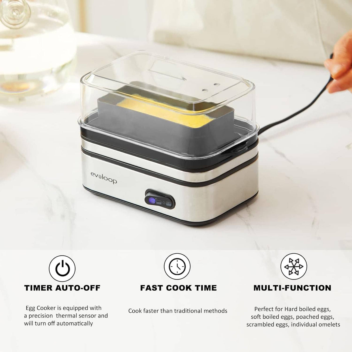Electric six-egg cooker on countertop with clear cover and visible control panel