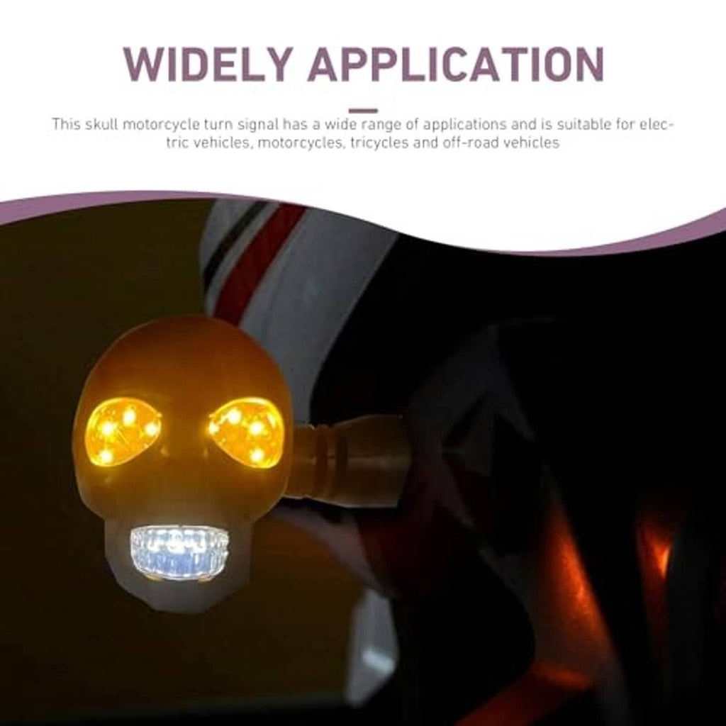 Amber and white skull-shaped LED turn signal light mounted on a motorcycle