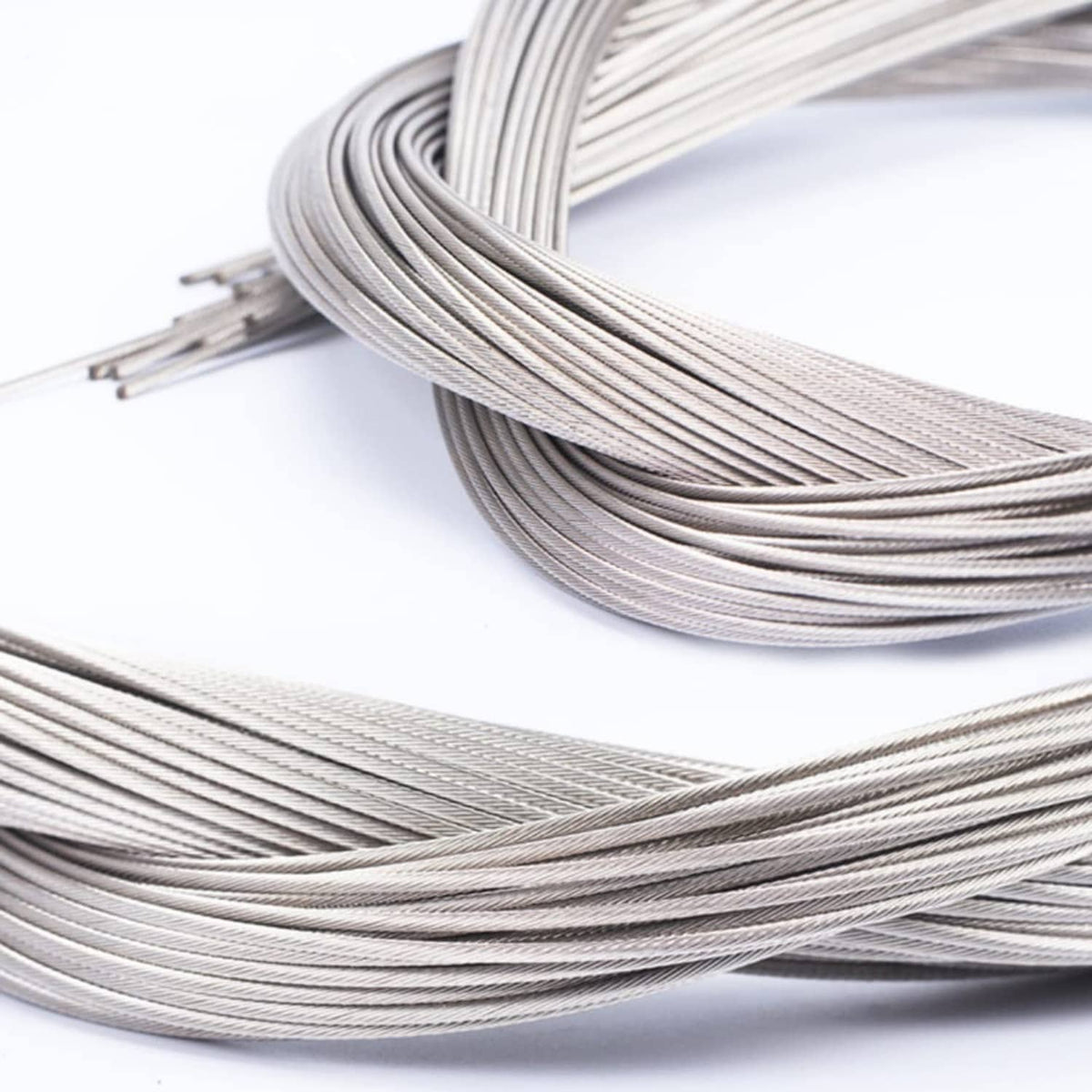 Curled stainless steel shifter cables with braided wire and metal sleeve ends