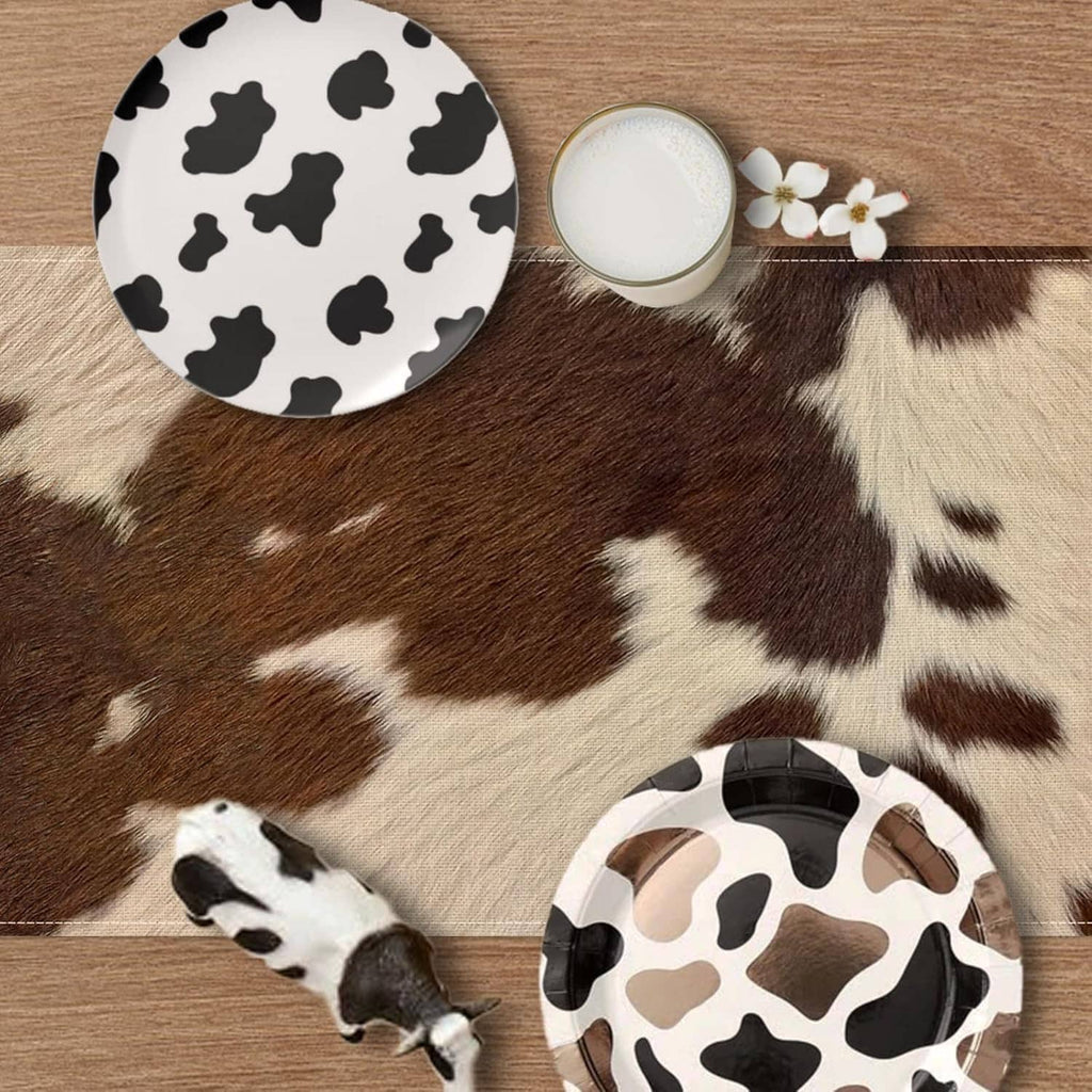 Cow print table runner with brown-and-white patches on beige base