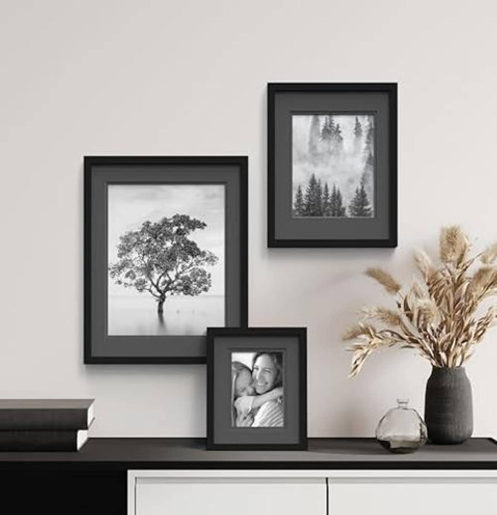 Black wood wall photo frame with white mat, showing a small portrait print