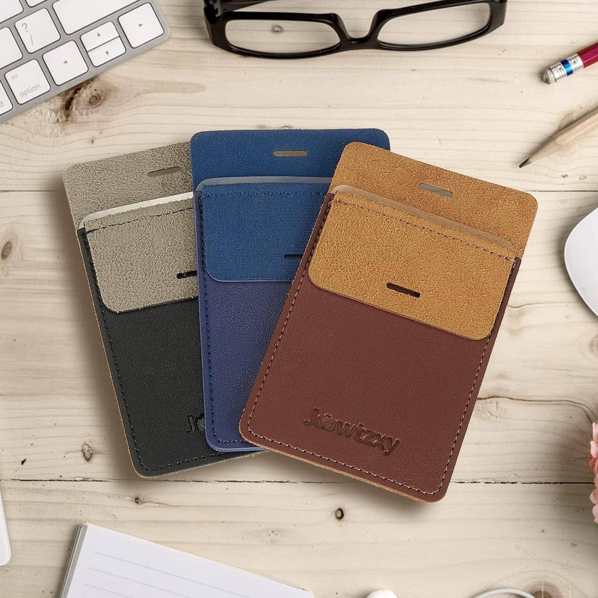 Set of three leather pocket pen holder pouches, gray, blue, and tan, stacked