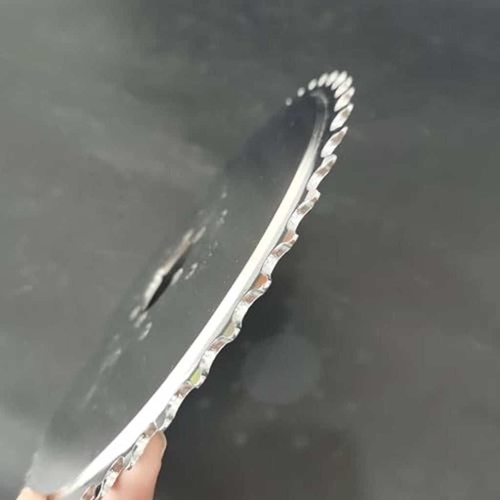 Close-up of steel sprocket teeth on the edge with mounting holes along the rim