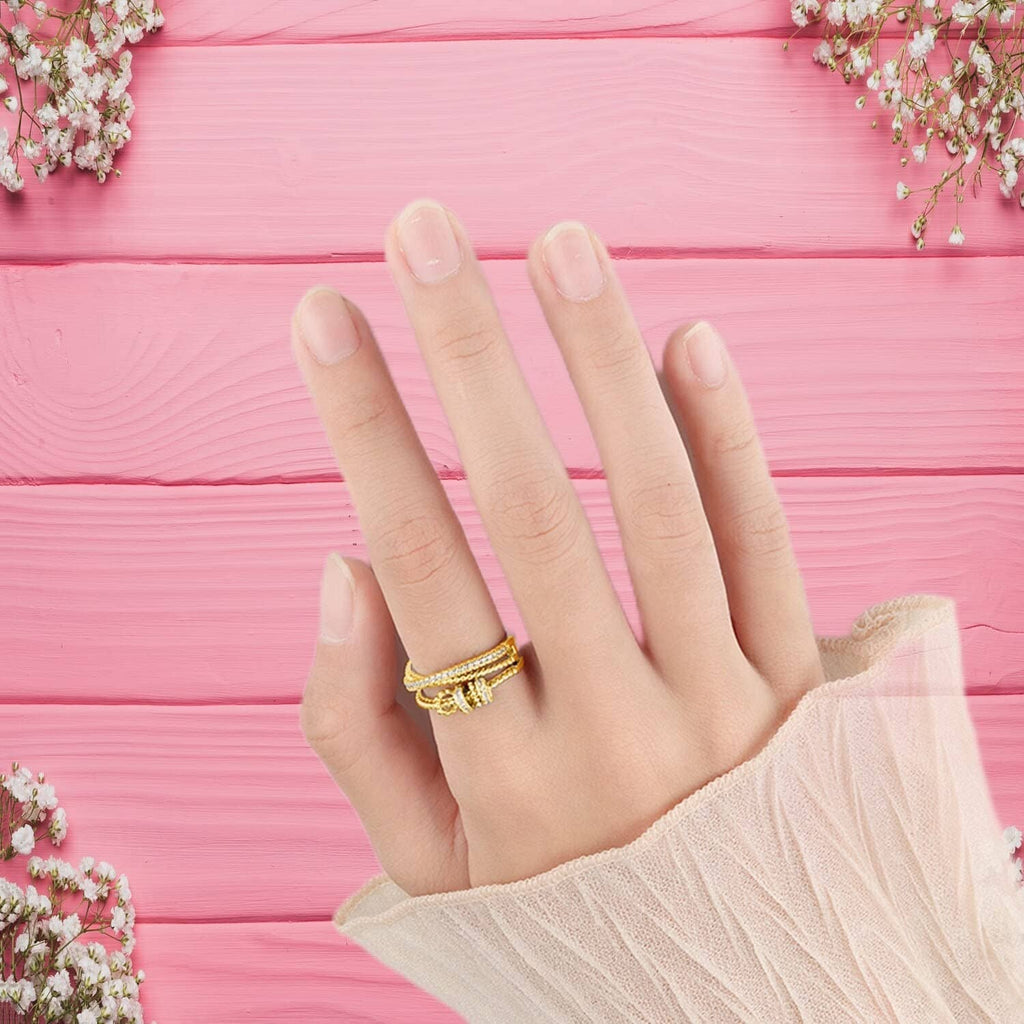 Gold-tone adjustable fidget ring on hand with stacked clear-stone bands