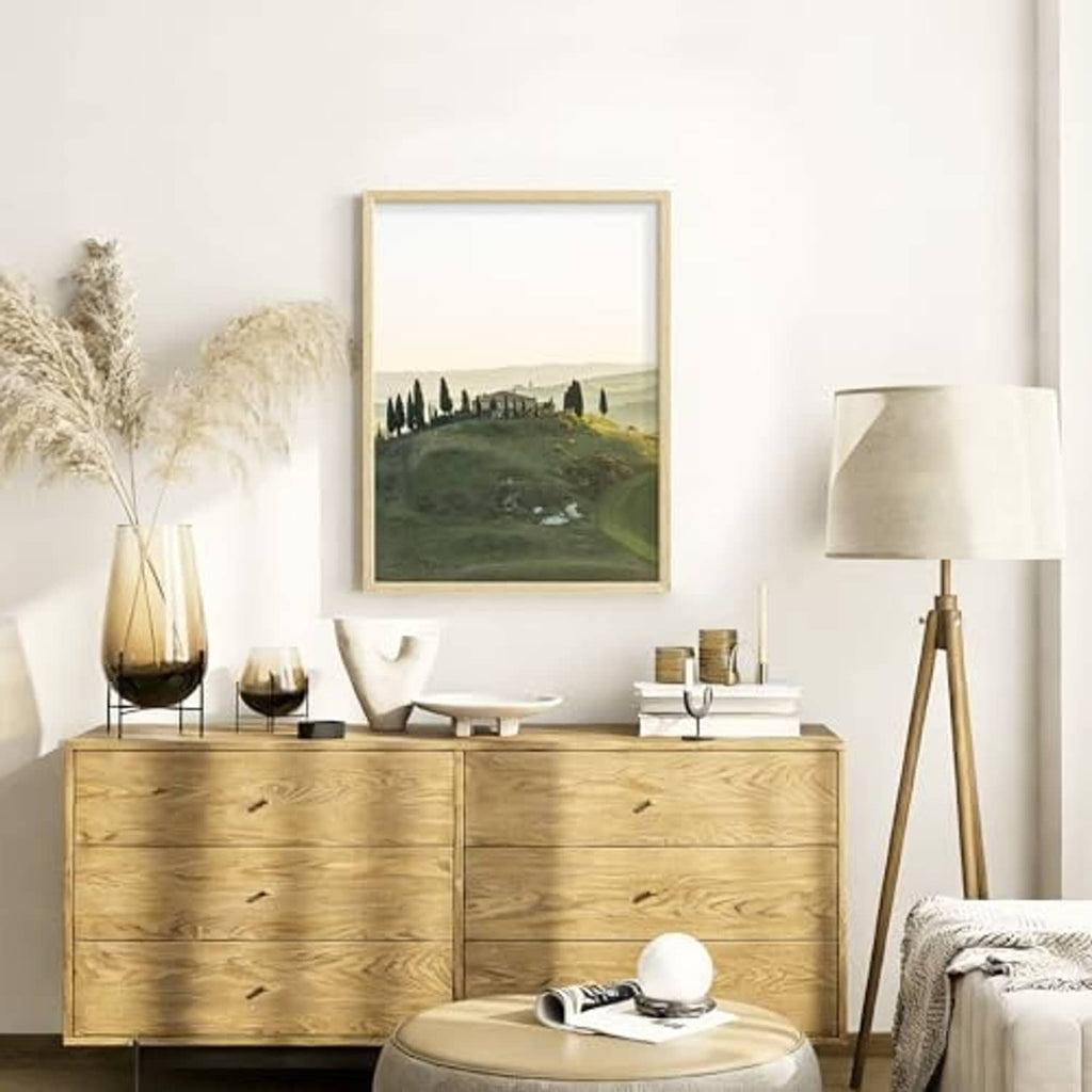 Natural wood picture frame with landscape art and clear front glass