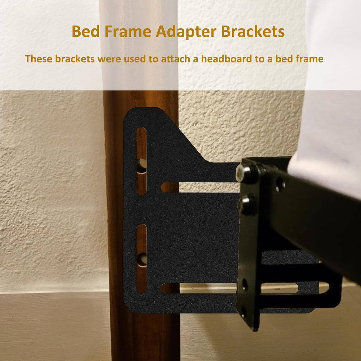 Black bed frame adapter bracket attached to wooden headboard support with mounting hardware