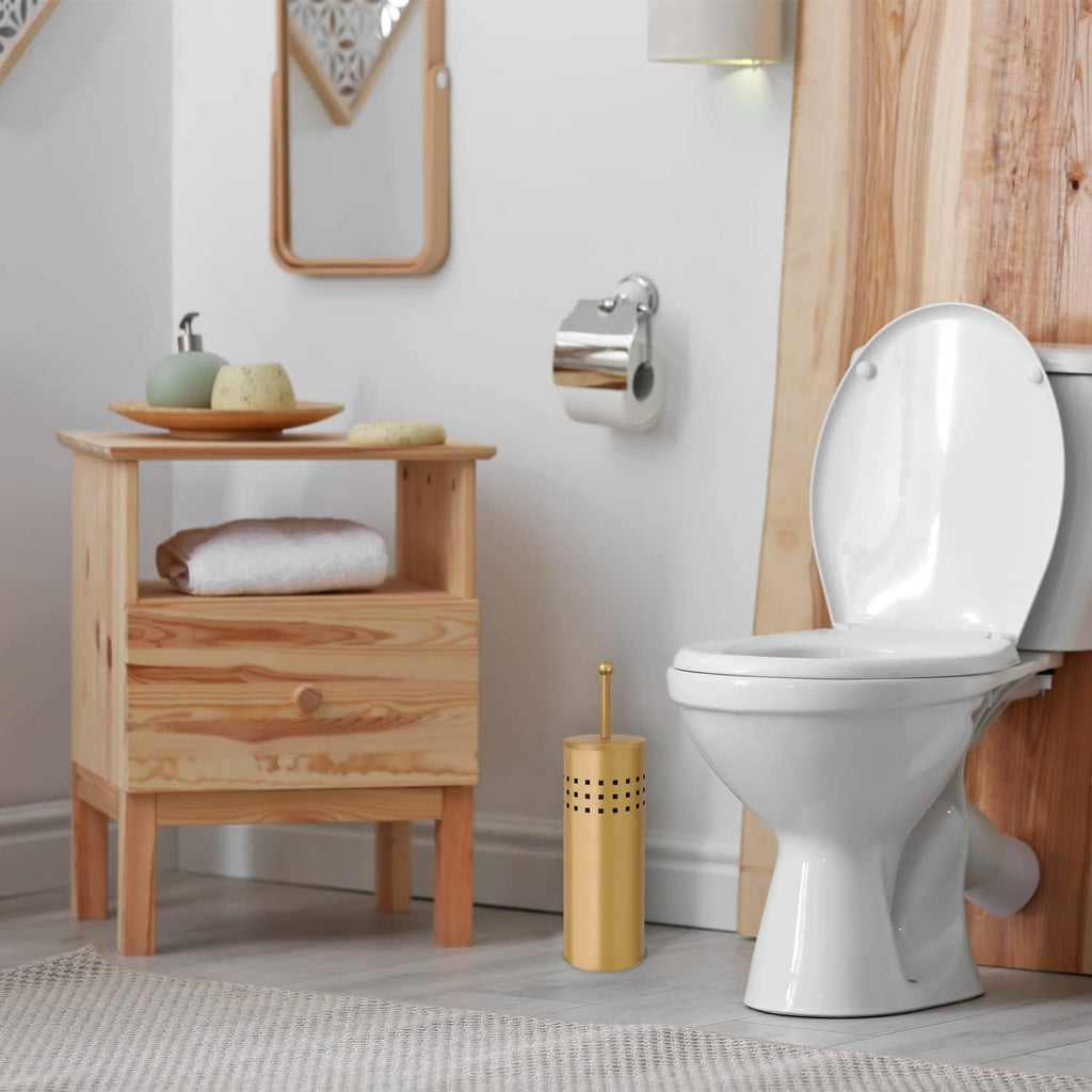 Gold toilet plunger with holder beside a white toilet in a bathroom setting