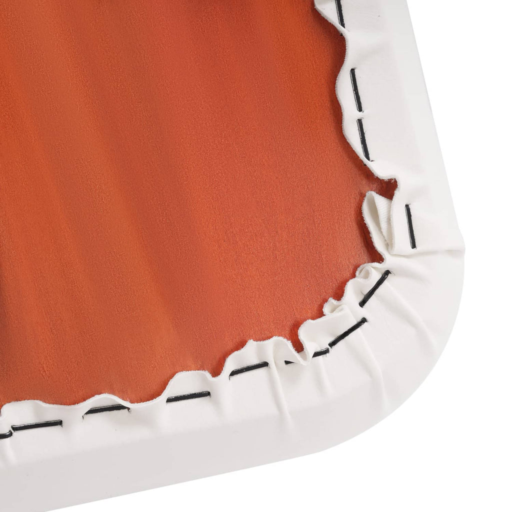 Orange cushion insert with white stitched trim edge and curved molded corner