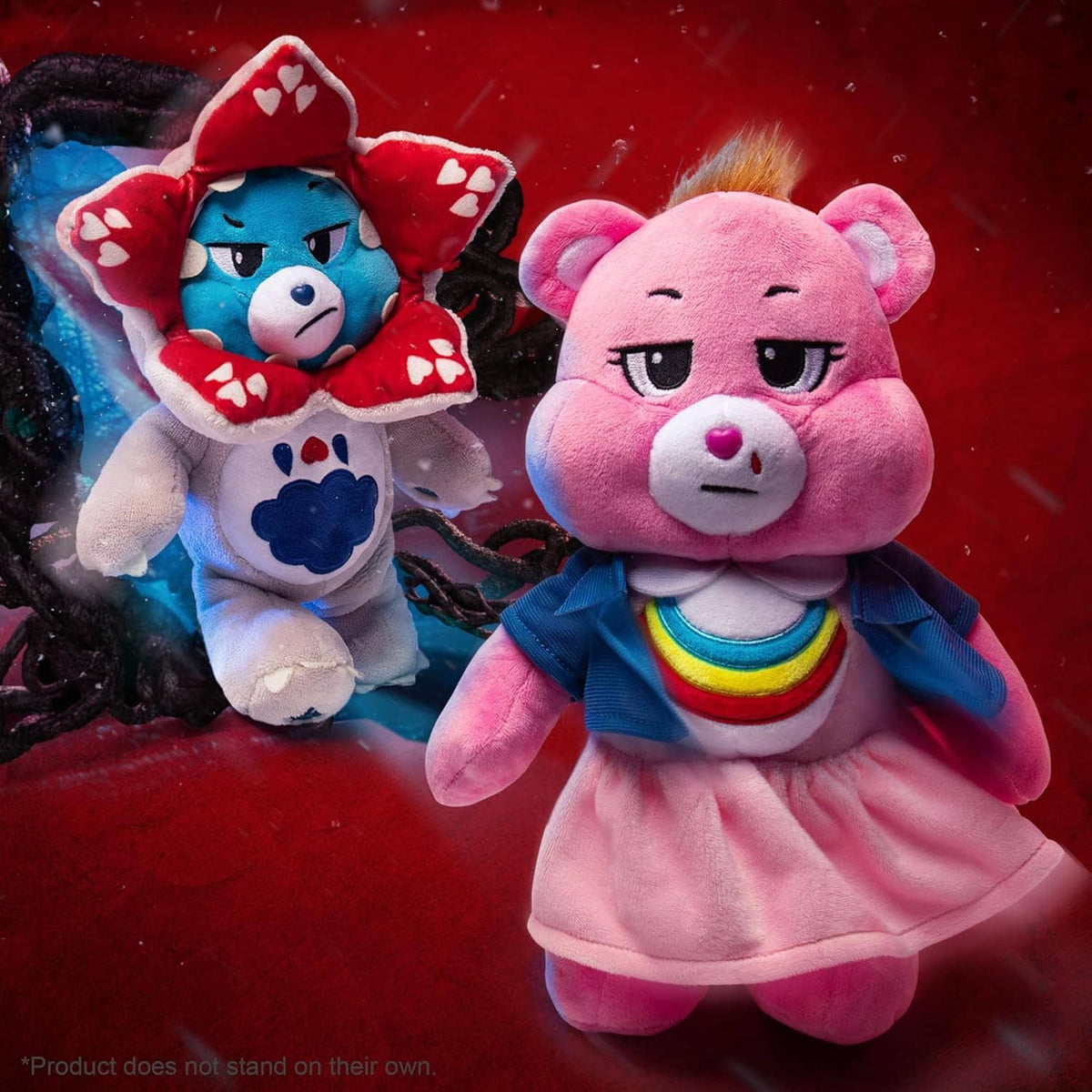 Two plush bear characters together: blue bear in red heart hood and pink bear