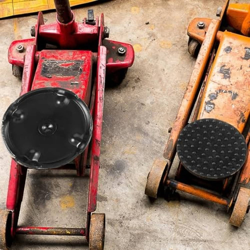 Rubber floor jack saddle pads installed on car jacks, black studded surfaces