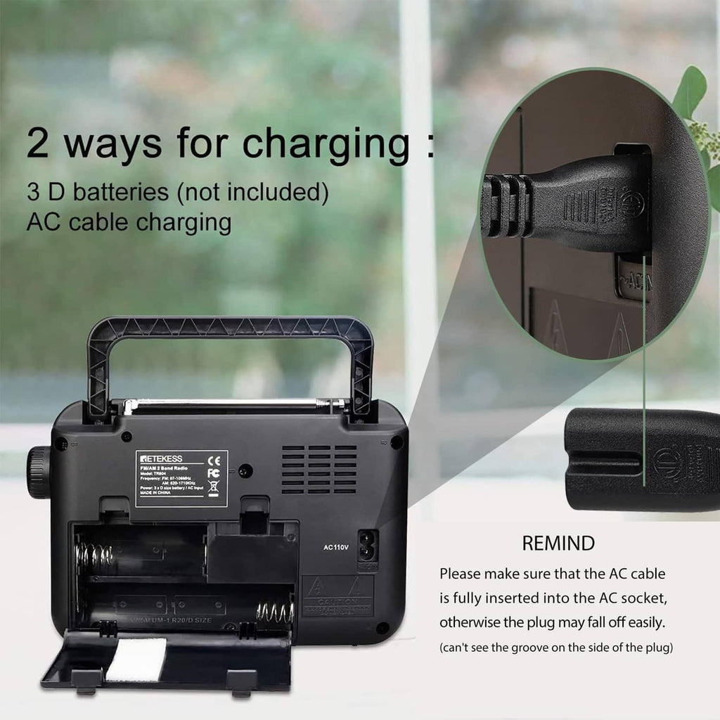 Portable AM/FM radio with open battery compartment and charging ports on the back
