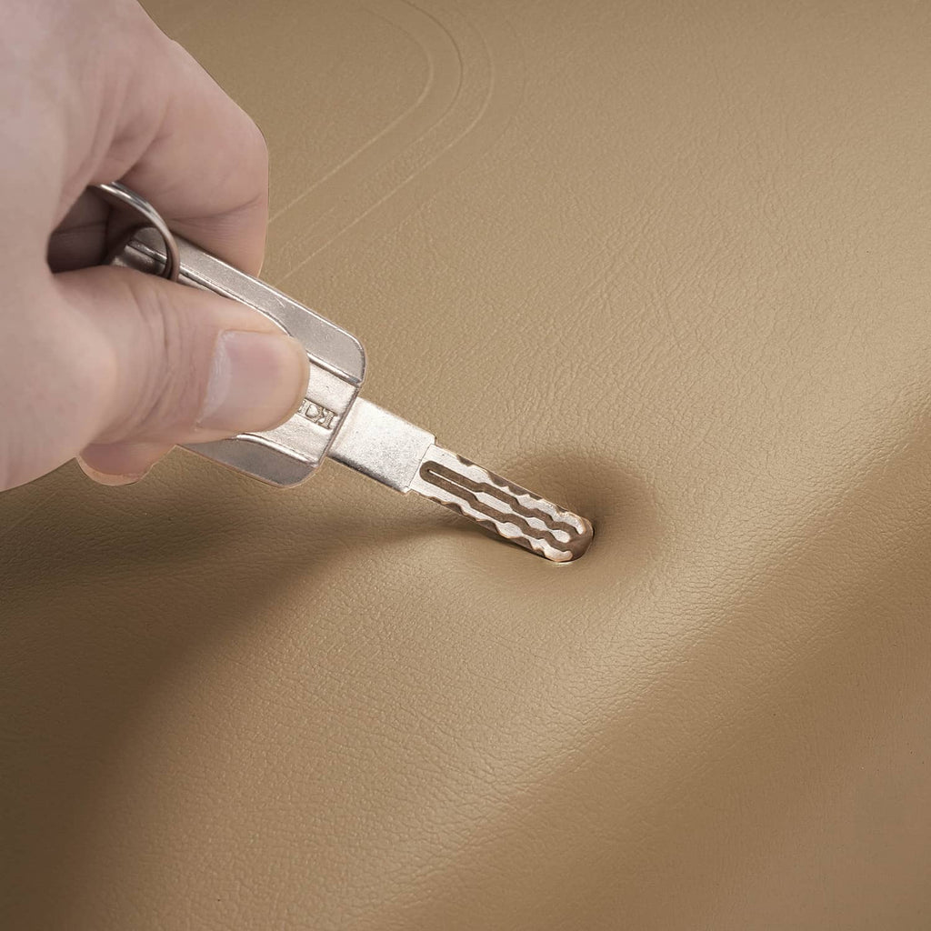 Tan cushion surface with metal latch key inserted for fastening
