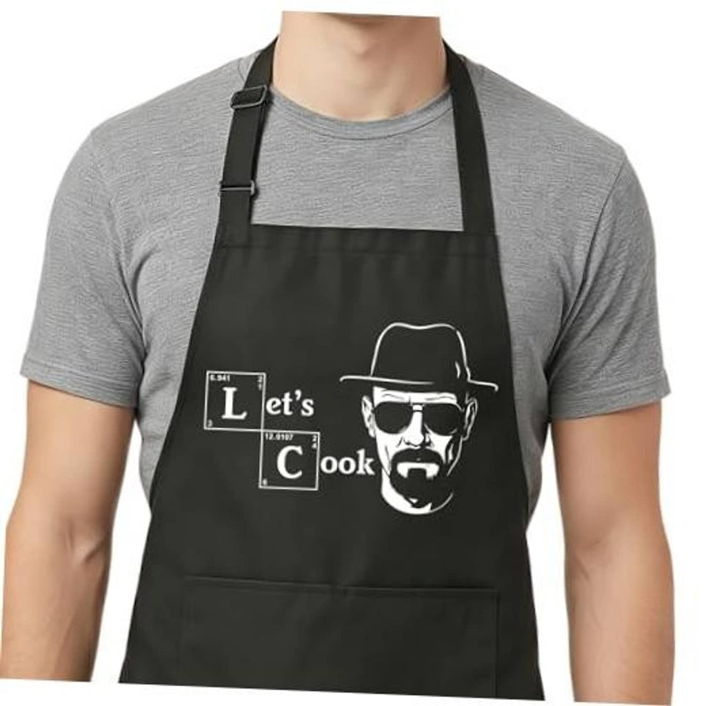 Black cooking apron with adjustable bib straps and “Let’s Cook” graphic front