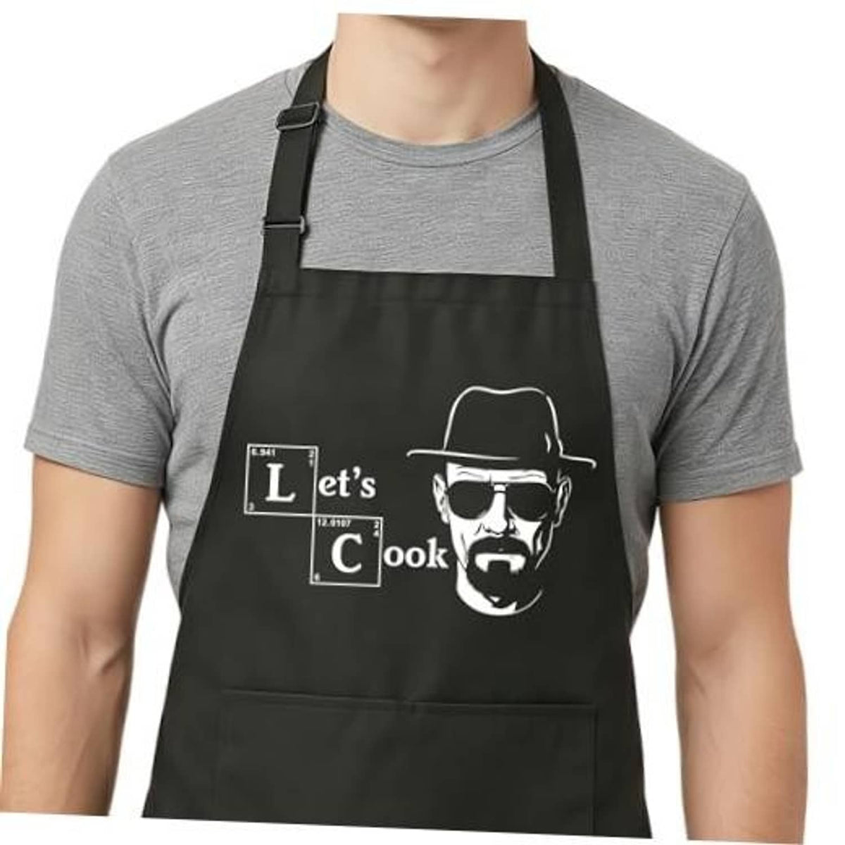 Black cooking apron with adjustable bib straps and “Let’s Cook” graphic front