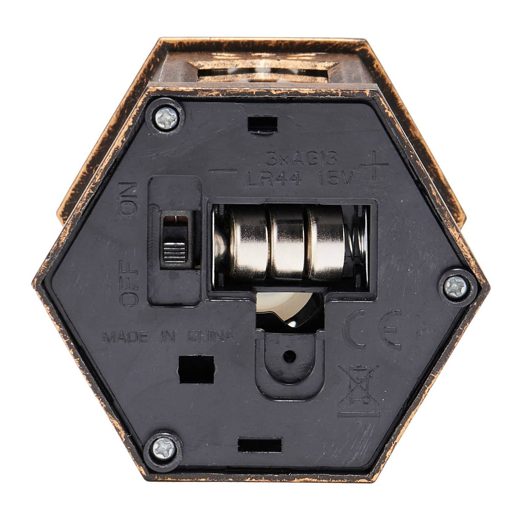 Bronze lantern underside showing battery compartment cover, spring and metal contacts