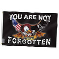 Black POW/MIA flag with eagle, U.S. flag, and “You are not forgotten” slogan