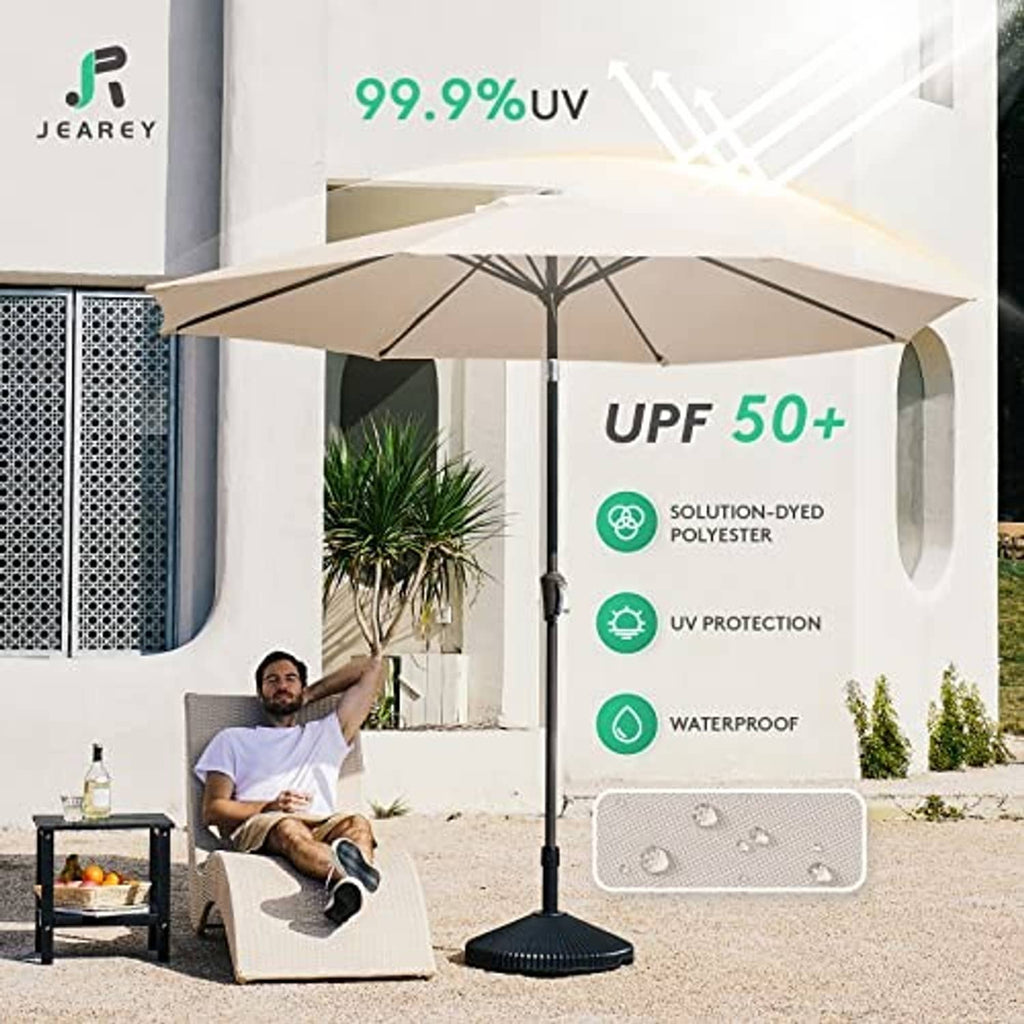 Beige patio umbrella open over outdoor seating with center pole