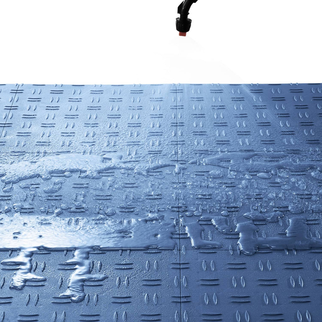 Interlocking blue garage floor tile with raised grip pattern and stud details