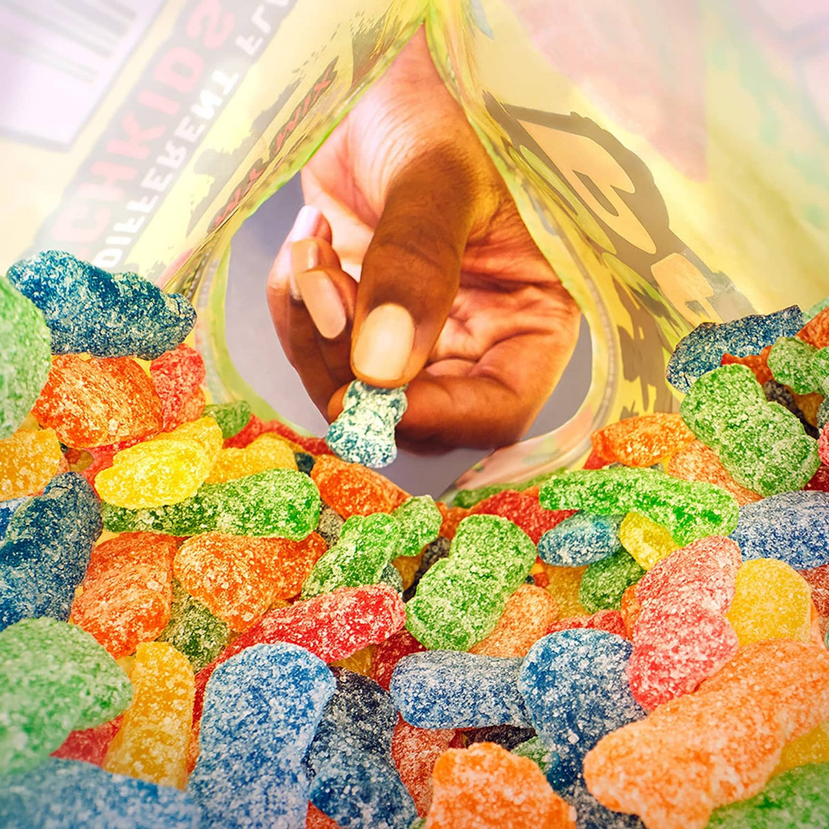 Colorful assortment of sour candy pieces scattered around a child figure in the background