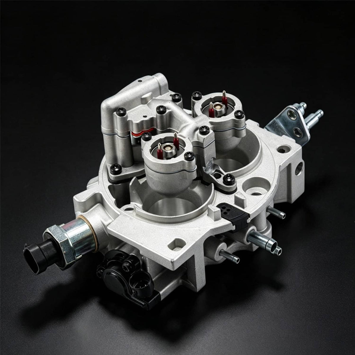 Throttle body assembly in angled view with metal housing, ports, and fittings