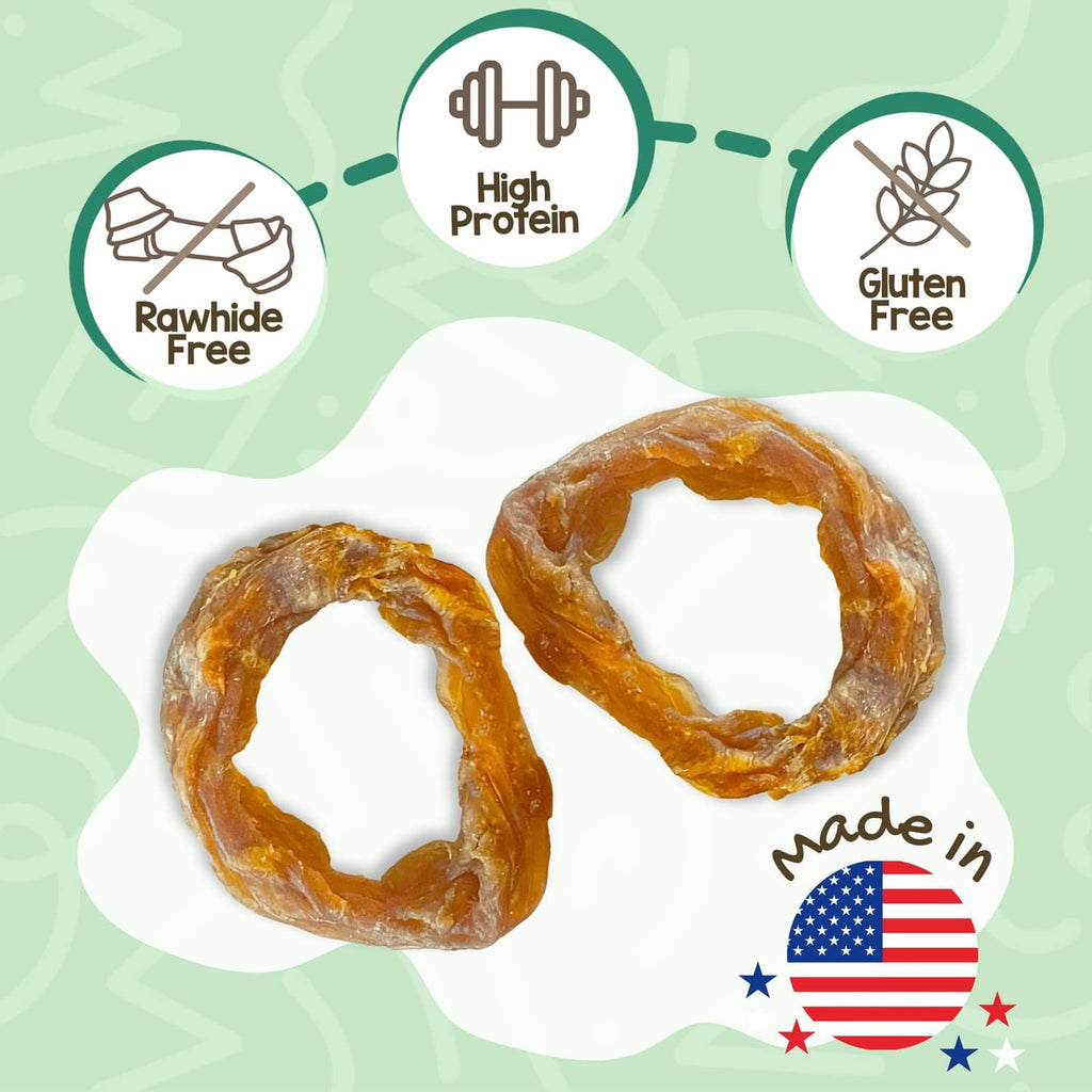 Two orange-brown turkey tendon ring dog chews, twisted loop shape