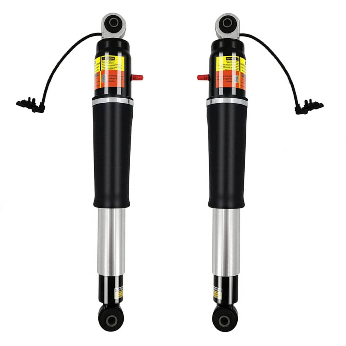 Shock absorber pair with black bodies, silver cylinders, and top eye mounts