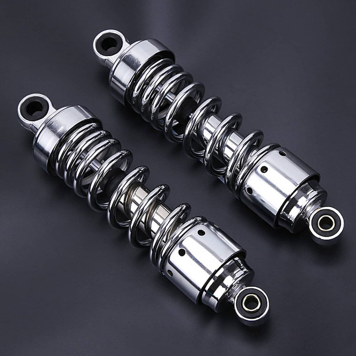 Chrome rear shock absorbers with dark coil springs, angled close-up view