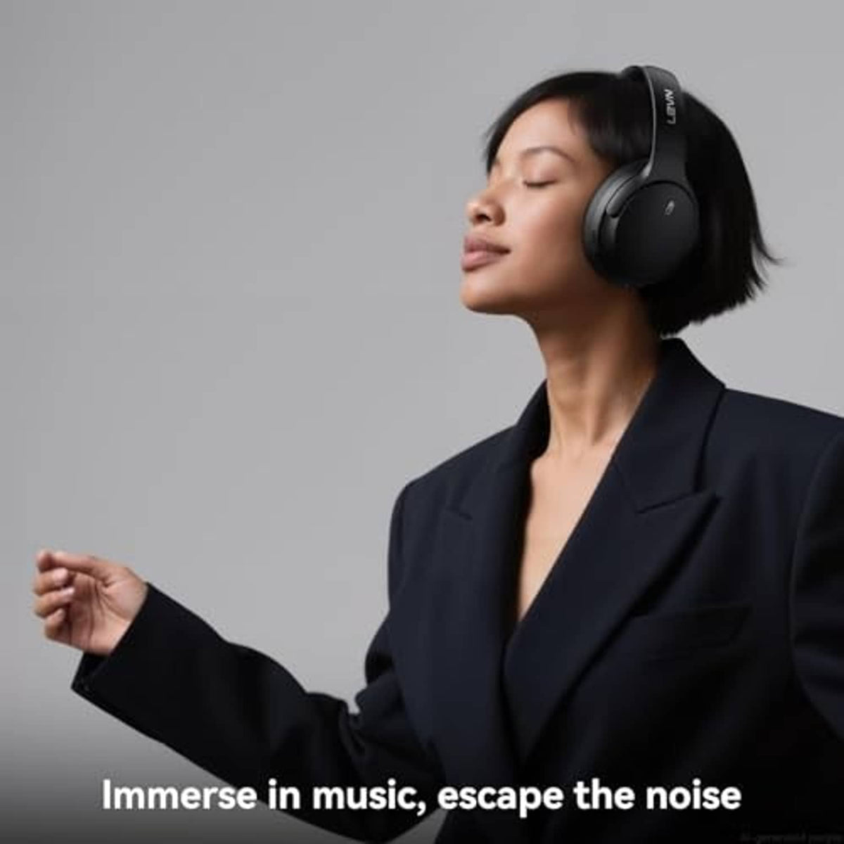 Black over-ear wireless active noise cancelling headphones worn by a person indoors