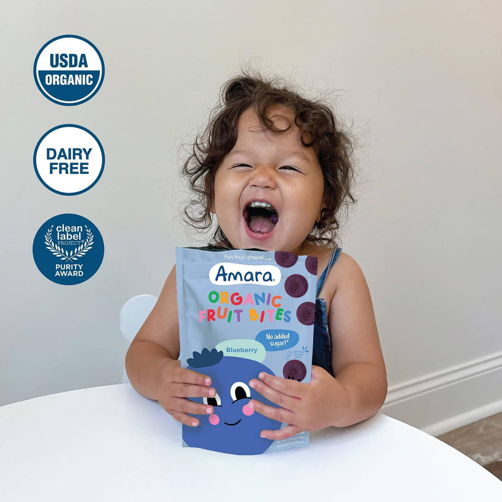 Amara Organic Fruit Bites blueberry pouch held by smiling child
