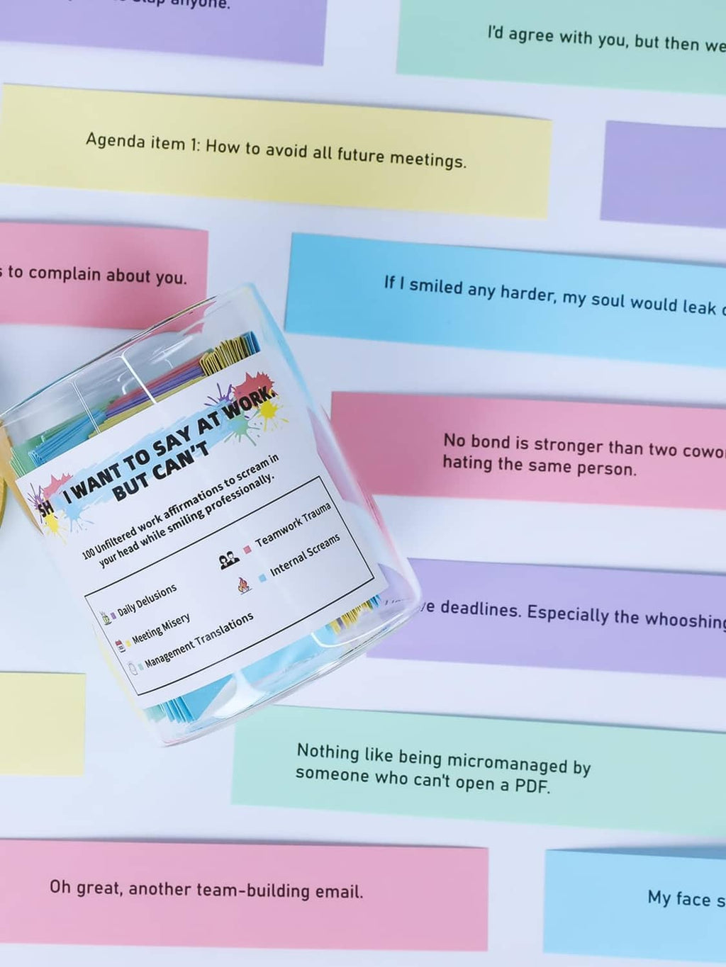 Color-coded affirmation notes spilling around a glass jar with wood lid