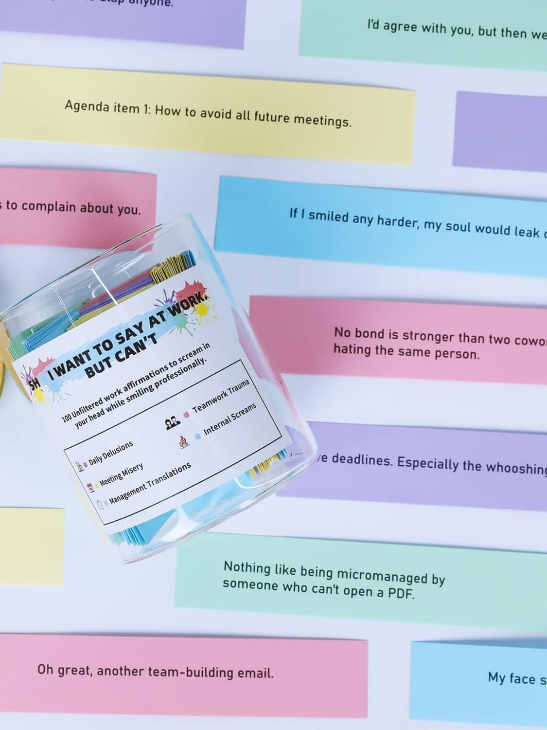 Color-coded affirmation notes spilling around a glass jar with wood lid