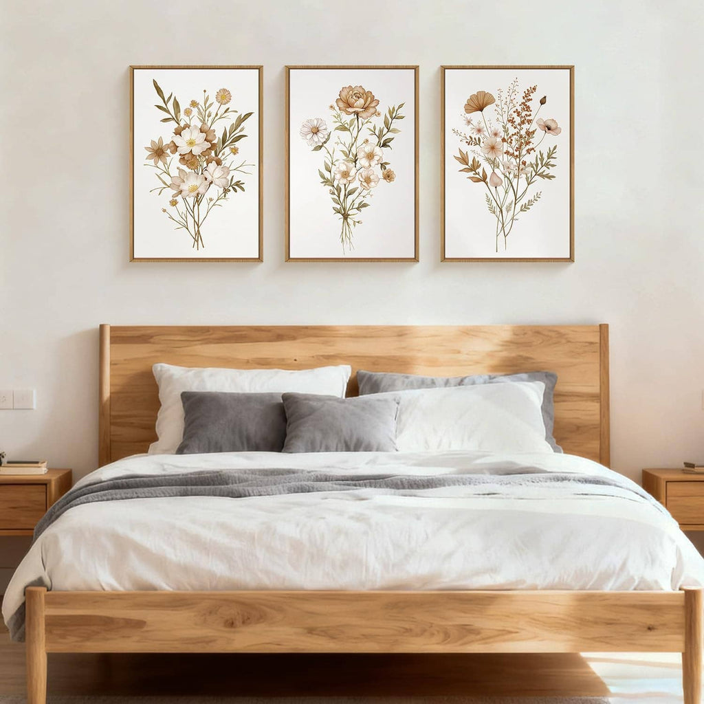 Three framed botanical flower canvas prints with gold frames on wall