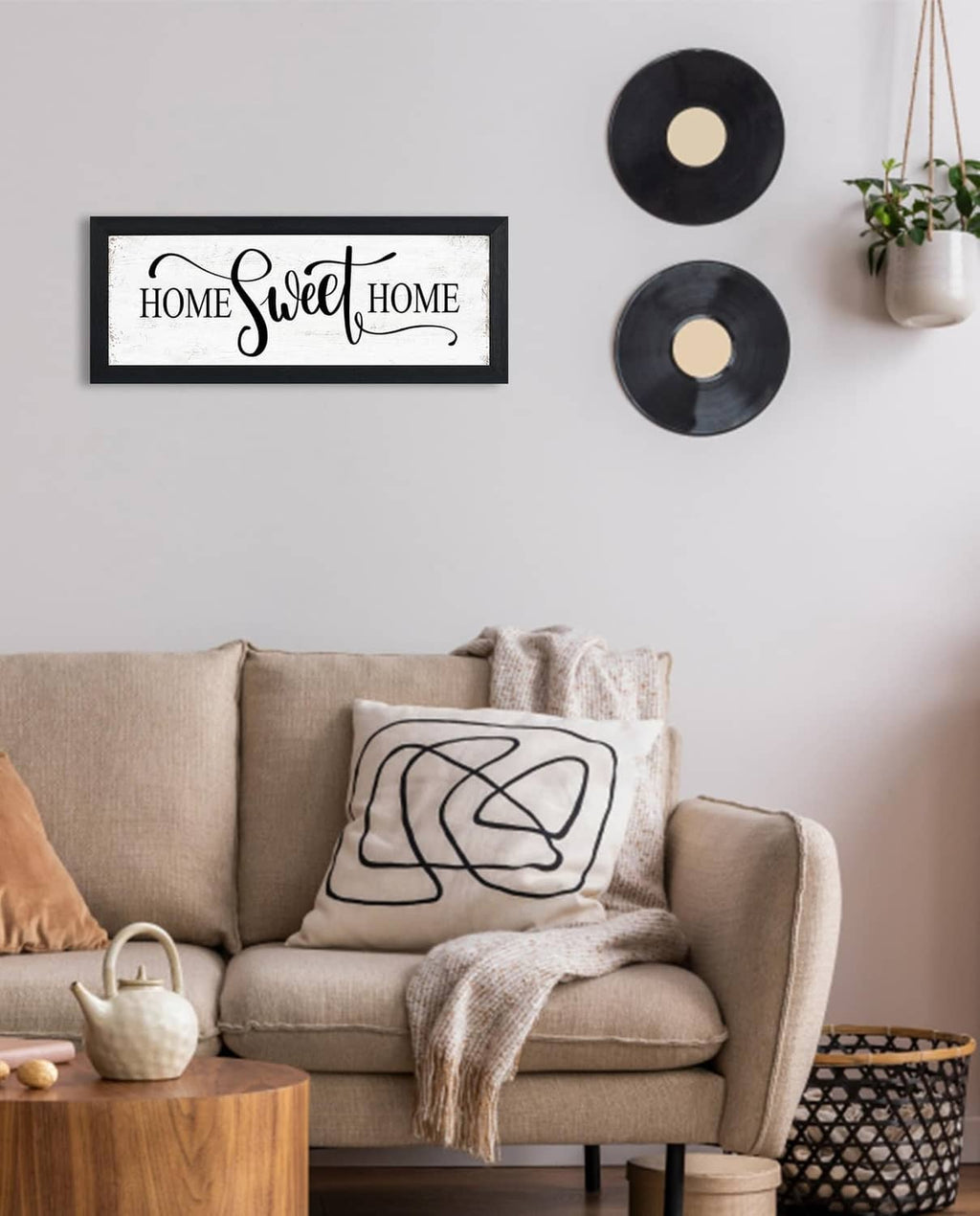 Black-framed wall decor sign with “HOME Sweet HOME” text and script