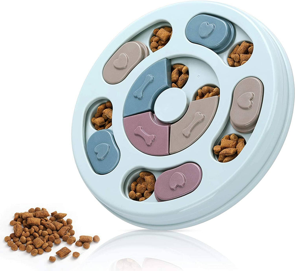 Round dog treat puzzle feeder with rotating pastel sections and scattered kibble treats
