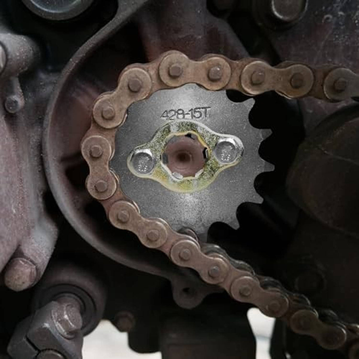 428-15T sprocket wheel installed on front engine with drive chain around it