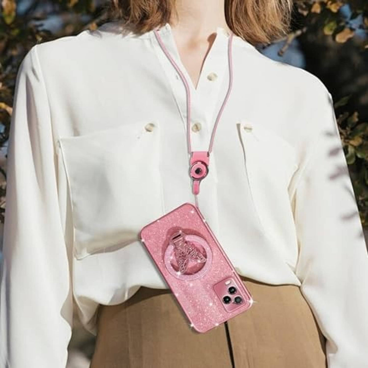 Rose gold glitter phone case worn on a lanyard with butterfly magnetic ring stand