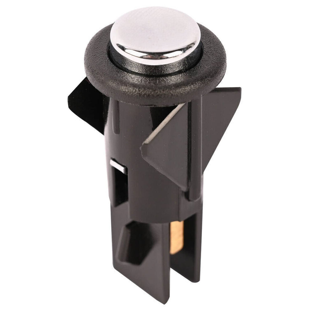 Black fuel door release switch with circular chrome button and side tabs