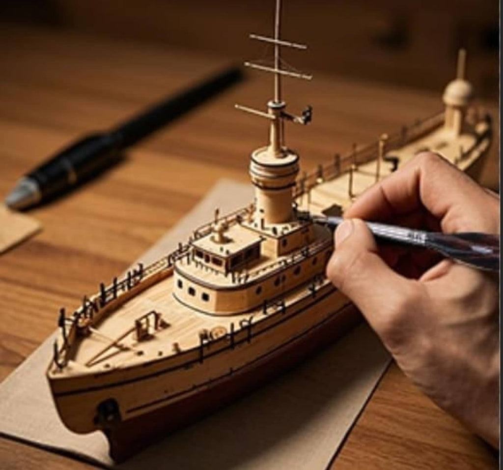 Artist paint brush in use on a small model ship on tabletop