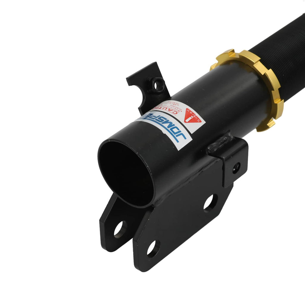 Black coilover strut mount bracket with label and red coil spring section, gold collar detail