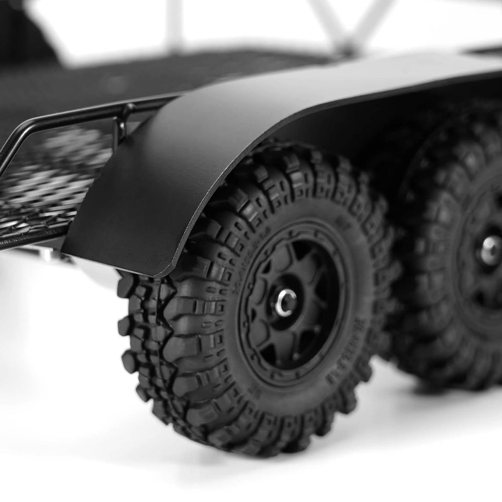 Black metal RC trailer with front hitch bar, mesh deck, and curved side fender