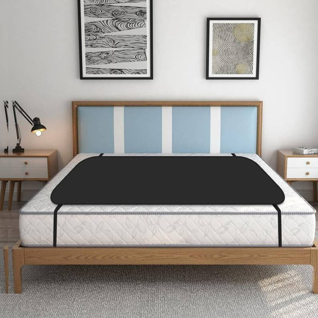 Grounding mattress pad with dark cover on bed base