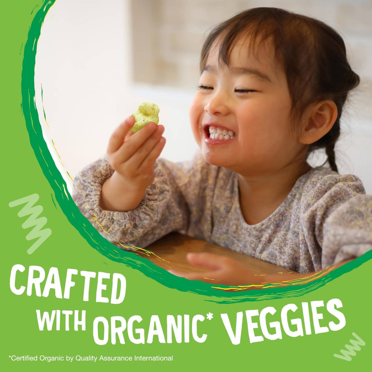 Organic veggie puffs promo with toddler eating puffs