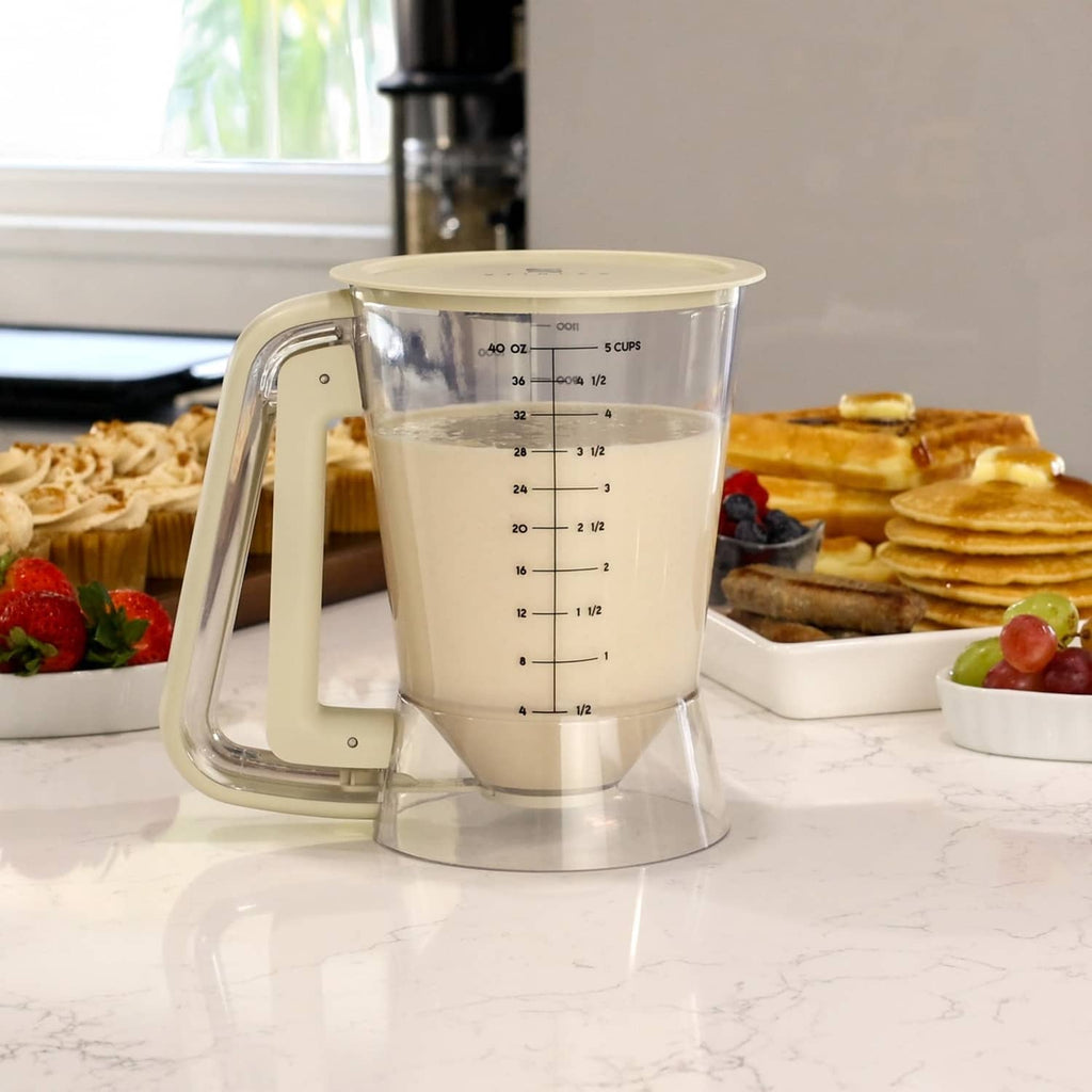 Beige 5-cup batter dispenser on countertop with clear cup and visible scale