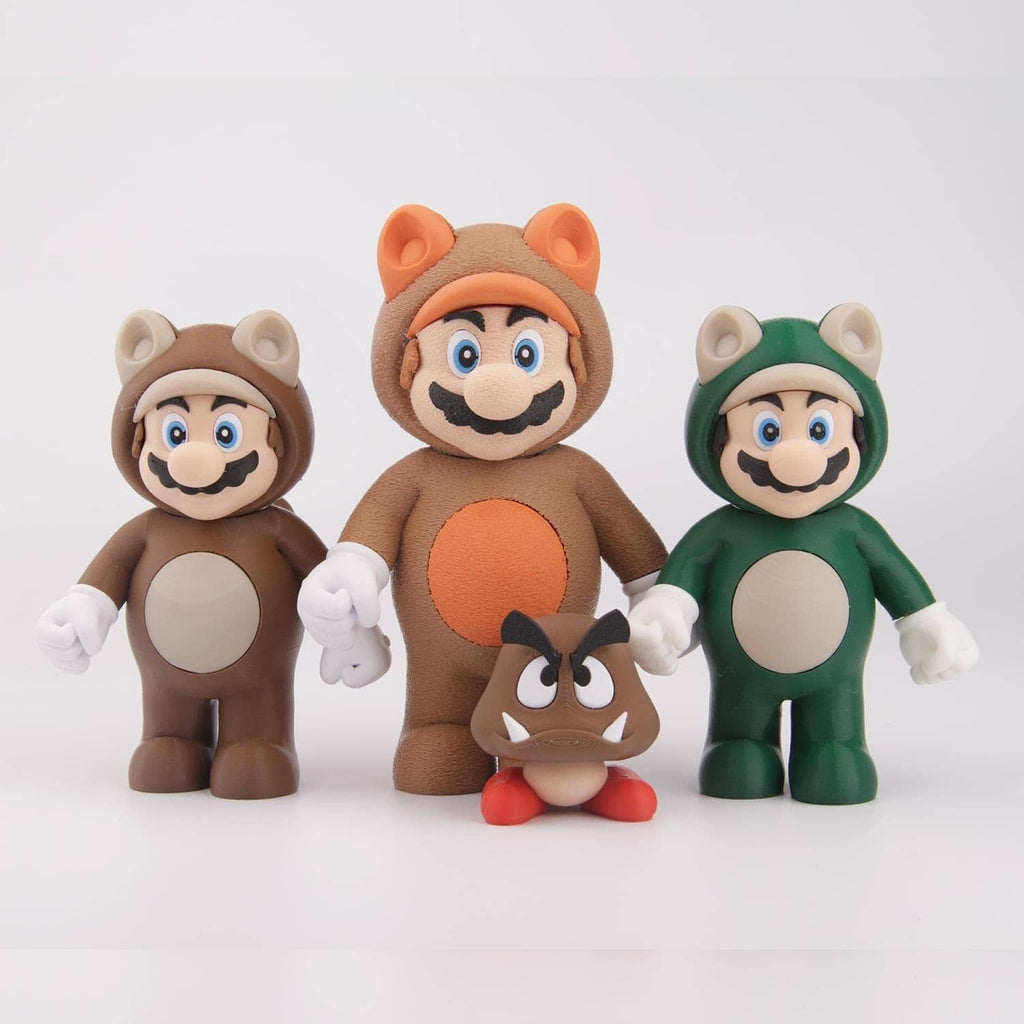 Set of brown, orange, and green 3D printed character figures with rounded heads and hands.