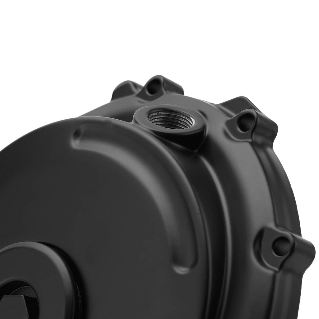 Close-up of black crankcase cover with oil cap opening and mounting holes
