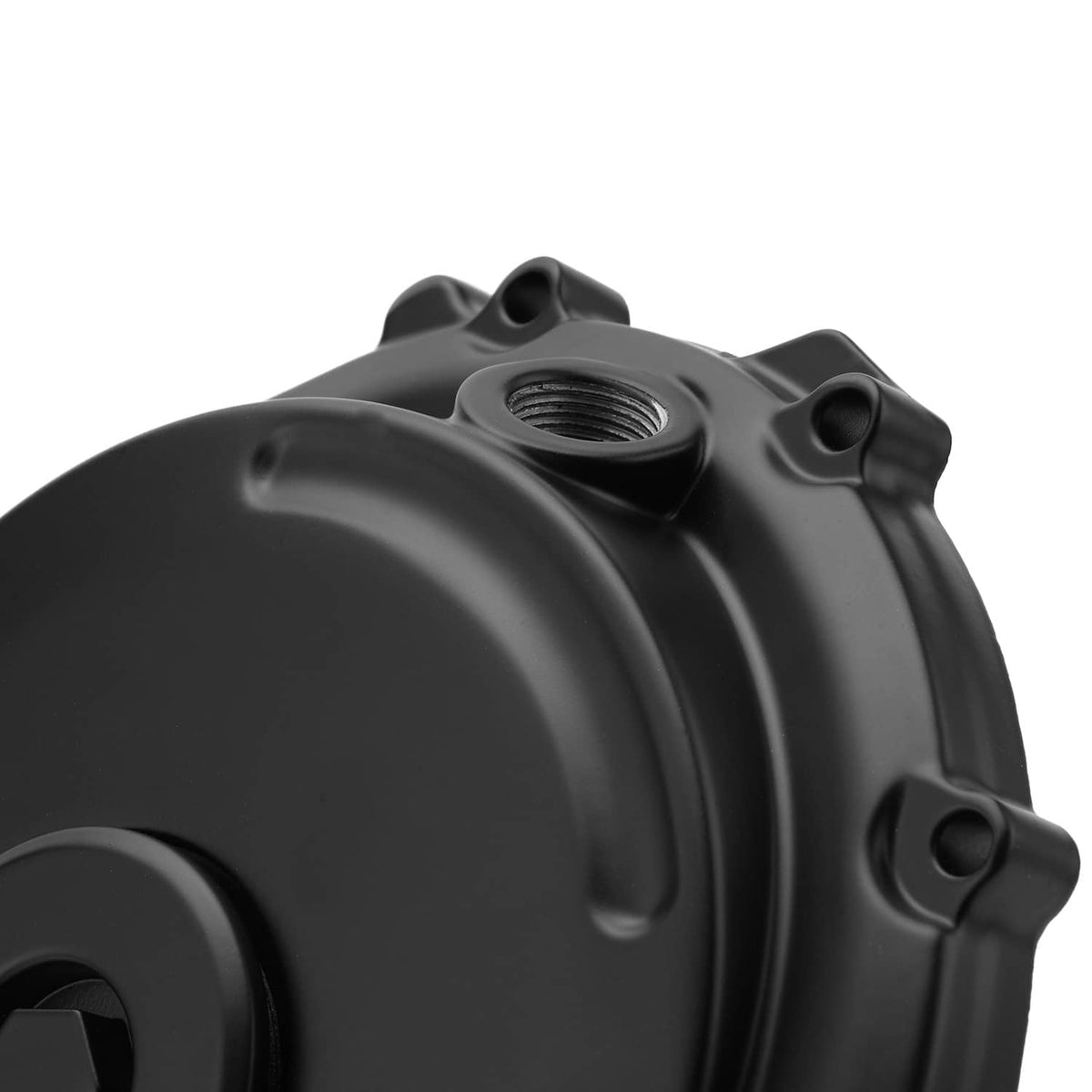 Close-up of black crankcase cover with oil cap opening and mounting holes