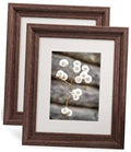 Dark brown wood picture frame set with white mat and floral photo insert.