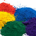 Iron oxide pigment powder granules in red, blue, yellow, green, and purple piles