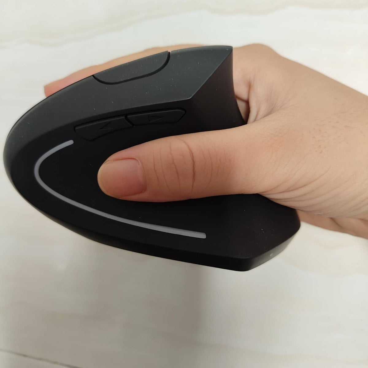 Ergonomic rechargeable mouse in black with curved thumb rest and finger buttons