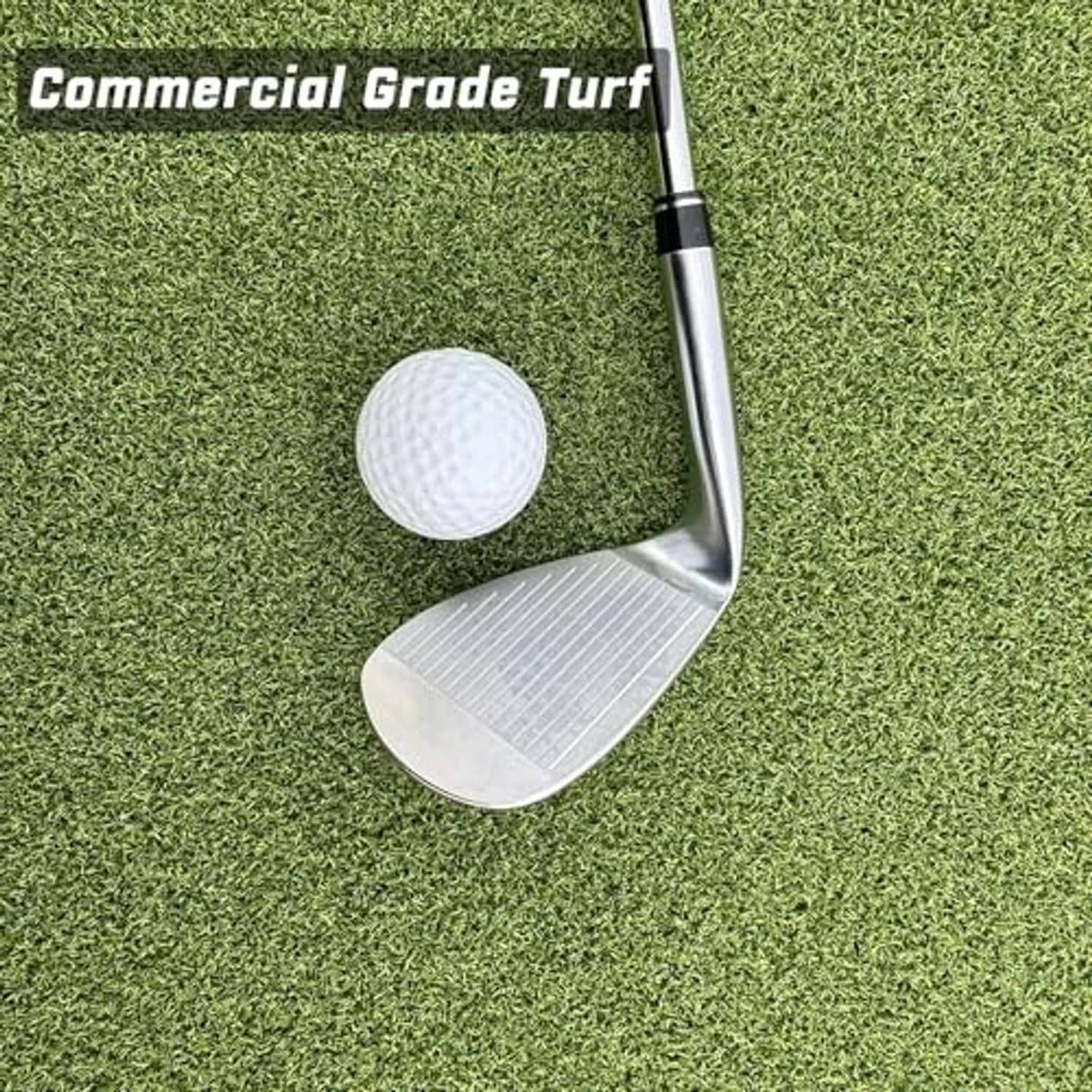 Green commercial golf turf with golf ball and club head on the hitting surface